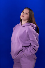 Young girl posing and moving on a blue background	