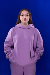 Young girl posing and moving on a blue background	