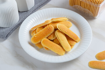 Kue lidah kucing or cat's tongue cookies. Traditional cookies for eid holiday in Indonesia. Perfect for recipe, article, catalogue, or any commercial purposes.