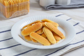 Kue lidah kucing or cat's tongue cookies. Traditional cookies for eid holiday in Indonesia. Perfect for recipe, article, catalogue, or any commercial purposes.