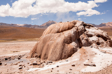 Tatio Geyser, Atacama Desert, Chile. Geyser steam in the desert with blue sky and clouds.