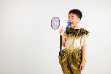 Portrait Thailand kid boy smiling traditional Thai dress costume shouting by megaphone, studio shot...