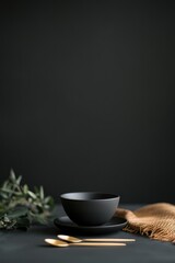 Elegant black bowl set against dark backdrop, accented by golden