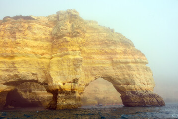 foggy landscape, the Algarve rock formation  is a unique and amazing natural wonder located in the coastal town of Porches, Portugal
