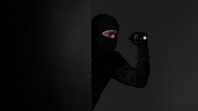 Shadowy Figure Partially Concealed Behind Wall