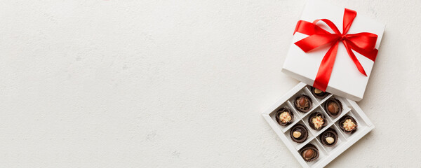 Delicious chocolate pralines in red box for Valentine's Day. Heart shaped box of chocolates top...
