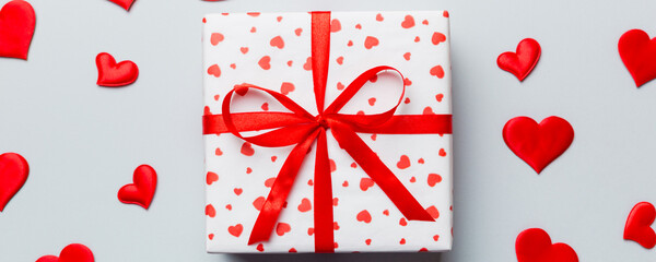 Valentine day composition Background: red gift box with bow and heart. Christmas present. View from...