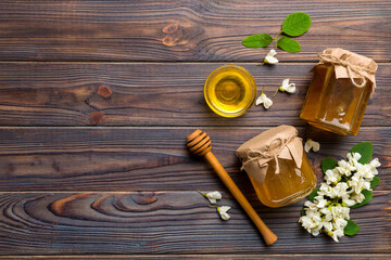 honey jar with acacia flowers and leaves. fresh honey top view flat lay