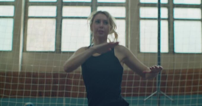 Fitness trainer preparing for jogging, student trainer exercising. Woman is doing jumping jeg exercise. Sport and fitness, training, workout concept.