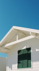 Fototapeta premium Minimalist white house facade with green shutter against clear blue sky
