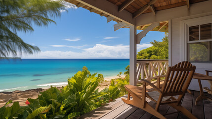 Fototapeta premium View from porch with a chair overlooking turquoise ocean, tropical forest, bright daylight, serene atmosphere.