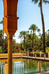 Palm-Framed Serenity in the Royal Alcázar Gardens: A Moorish-Infused Oasis with Reflective Pools,...