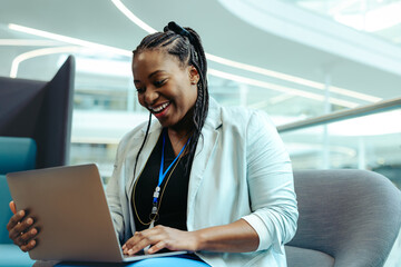 Confident female financial advisor working on a laptop in modern office