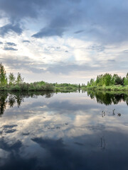 Fototapeta premium Calm lake with trees in the background