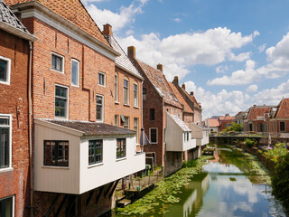 Houses with hanging kitchens over Damsterdiep canal in historic town of Appingedam, Eemsdelta, Groningen, Netherlands