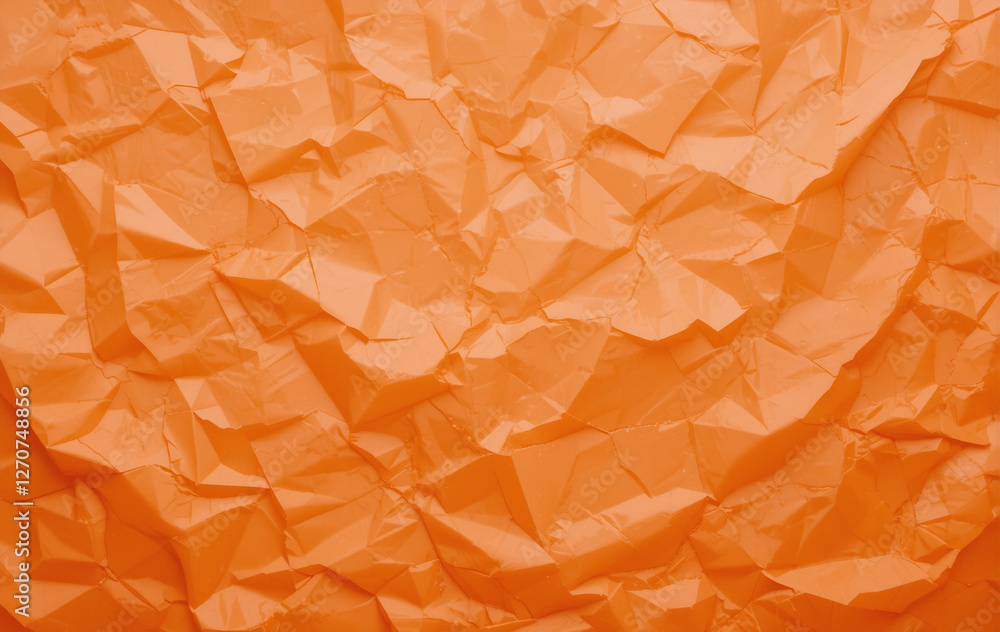 Poster orange crumpled paper with a textured surface, creating a warm, abstract pattern.