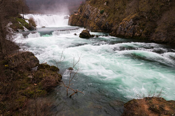 Waterfall and cascade on Una river, water sprays and flows in motion blur, turquoise colour