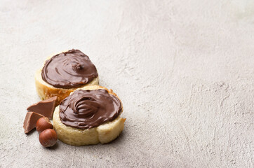 Chocolate sprad on bread with slick chocolate and filbert nuts