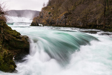 Waterfall and cascade on Una river, water sprays and flows in motion blur, turquoise colour
