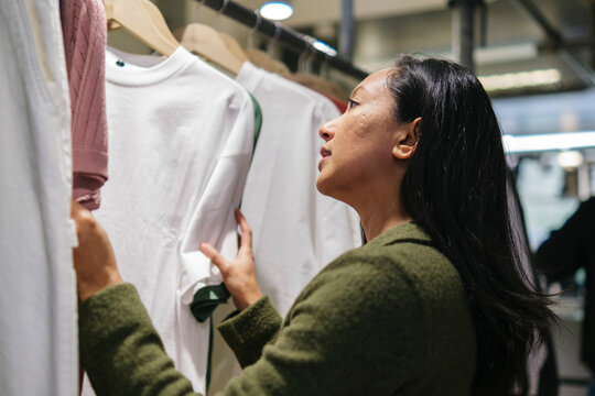 Woman choosing clothes in store