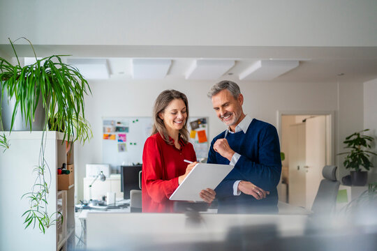 Business colleagues discussing in office using tablet pc