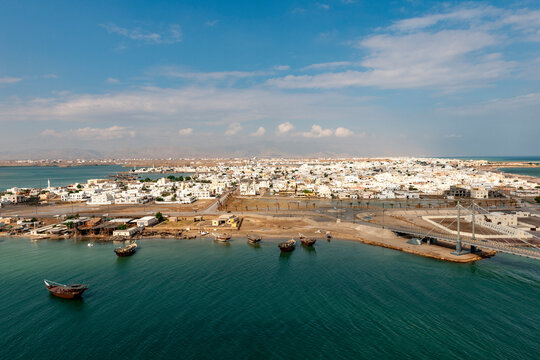 Aerial view of Sur, Oman with traditional dhows on the Gulf of Oman coast
