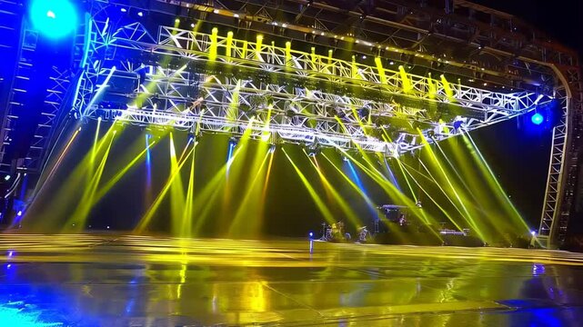 Colorful Light Show Illuminates Outdoor Stage During Evening Concert in Vibrant Setting