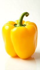 Closeup of a fresh yellow bell pepper showcasing its shiny texture and green stem