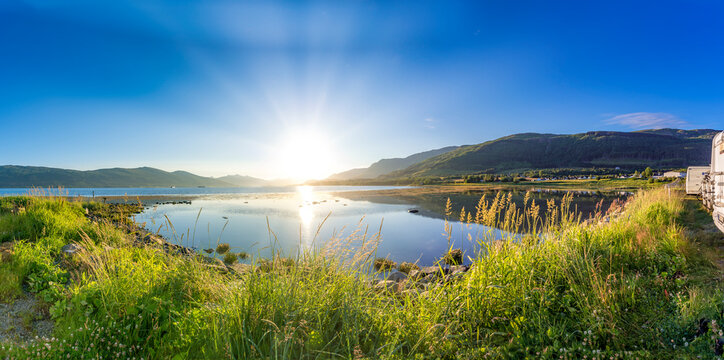 Scenic sunrise over the Atlantic coast in Helgeland, Norway with a parking lot and nobody around