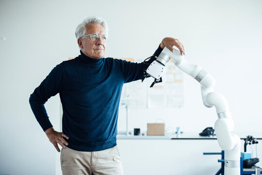 Engineer in a laboratory with a robotic arm