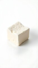Extreme closeup of a block of tofu against a clean background