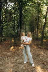 Fototapeta premium Mother Holding Child During Stroll in Peaceful Green Forest