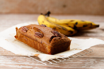 Banana bread loaf on wooden table.