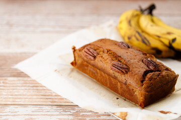 Banana bread loaf on wooden table.