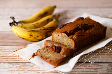 Banana bread loaf on wooden table.
