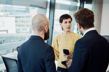 Colleagues in a modern boardroom having a discussion