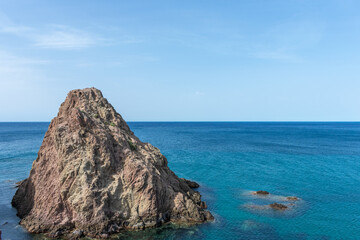 volcanic rock jutting out on the coast of the Mediterranean Sea