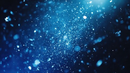 Fototapeta premium Blue glitter explosion, dark background, bokeh effect, design element