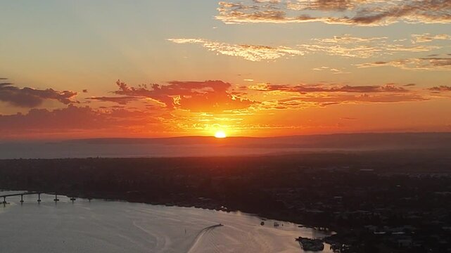 Aerial footage of the sun-setting over the Goolwa river port on the Murray River in SA, Australia