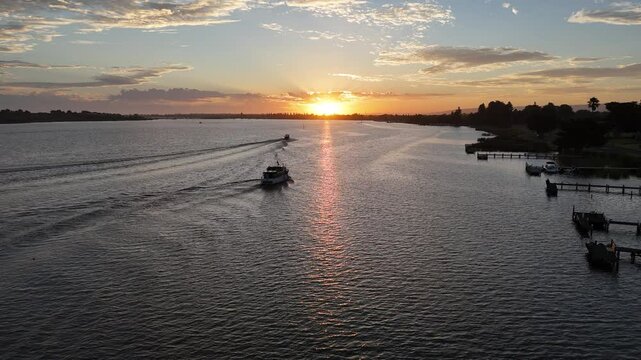 Drone footage of boats on the Murray River at Goolwa river port, SA, Australia, at sunset
