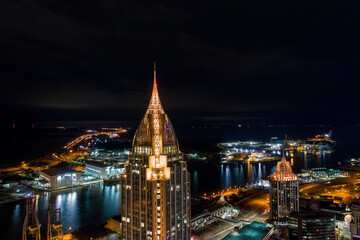 Obraz premium Downtown Mobile, Alabama and the bay at night during Mardi Gras Month