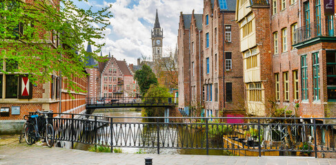 Downtown of Ghent with canal, clock tower, medieval houses, Belgium