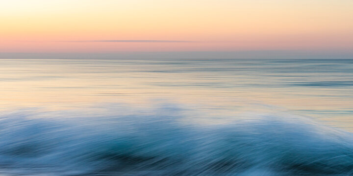 Abstract seascape at dawn with blurred waves in Menton, C�te d'Azur, France