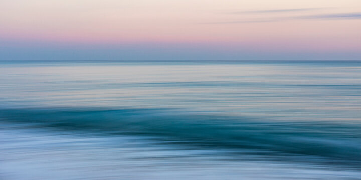 Abstract blurred seascape at C�te d'Azur, Menton, France with Mediterranean waves and afterglow.