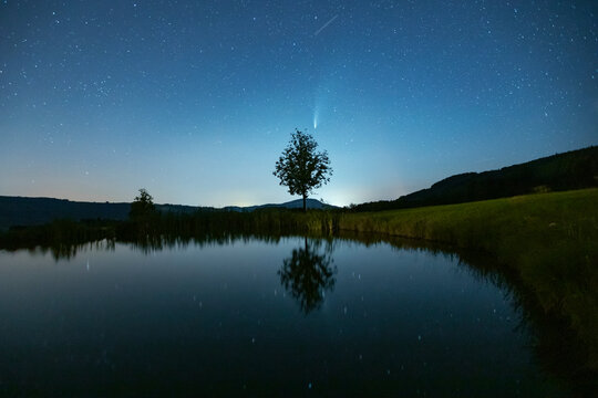 Night view of Comet Neowise over Mondsee in Salzkammergut, Austria