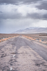 Asphalt road of the Pamir Highway in the valley of the Tien Shan Mountains in Tajikistan in the...
