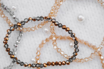 Elegant handcrafted beaded bracelets arranged on textured fabric backdrop