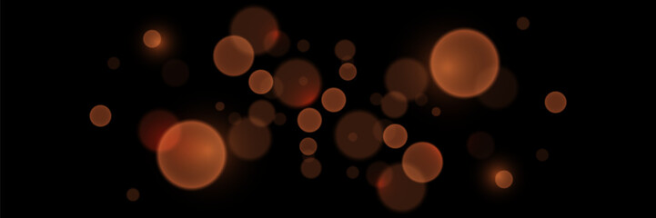 Abstract glowing bokeh lights. Bokeh and magic light effect. On a black background.