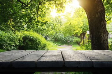 Naklejka premium Sunny park picnic table, green trees background