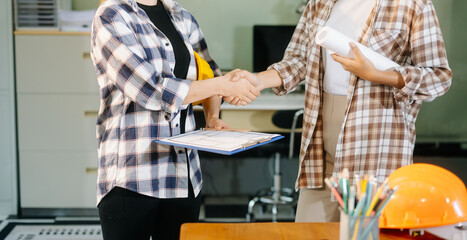 Engineer desk with object paper and tablet with blurry engineer teamwork hardworking